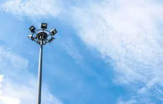 High mast lighting pole against the sky